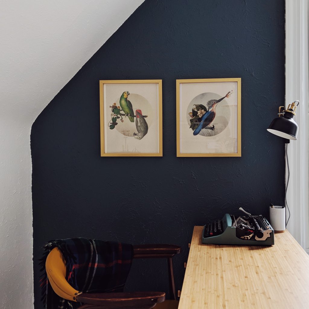 Home office painted white with a navy blue accent wall