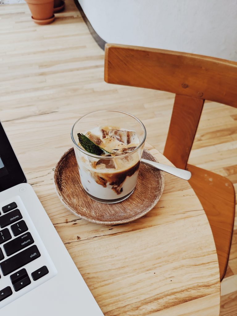 An iced latte in a sunlit coffee shop